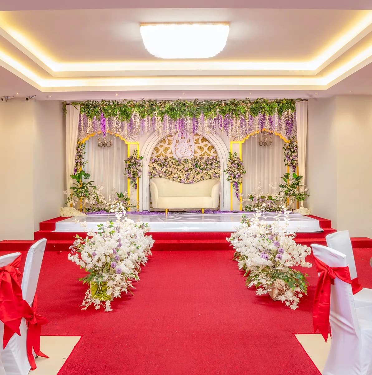 The GR Plaza banquet hall dressed for a wedding with a floral stage